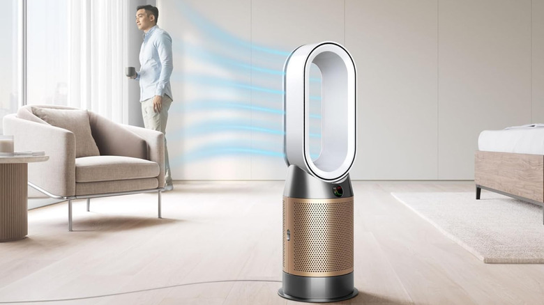 Person in a living room enjoying the air blown by a Dyson Purifier Hot+Cool HP2 De-Nox
