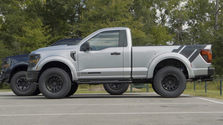 Two regular cab two-door Ford F150s parked next to each other.