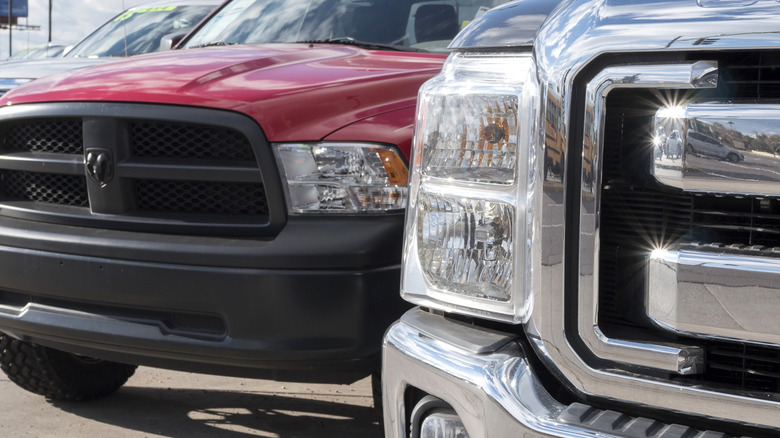 A close-up of a Dodge Ram and a Ford F-150 pickup.