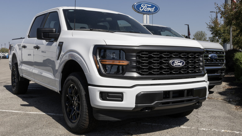 A white Ford F-150 parked on a dealership lot.