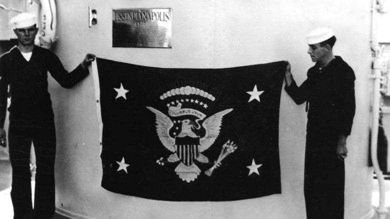 USS Indianapolis sailors display the flag of the president of the United States.