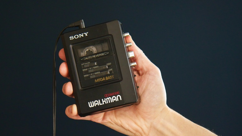 Hand holding up a Sony Walkman portable cassette player