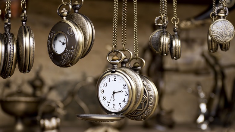 Multiple vintage pocket watches hanging