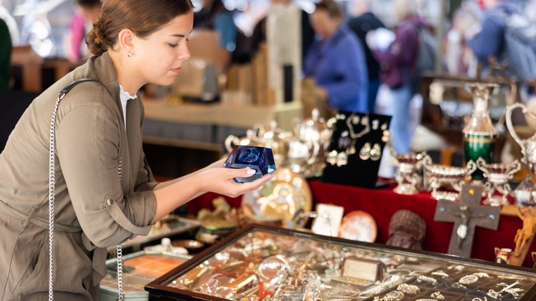 A person browsing goods at a flea market