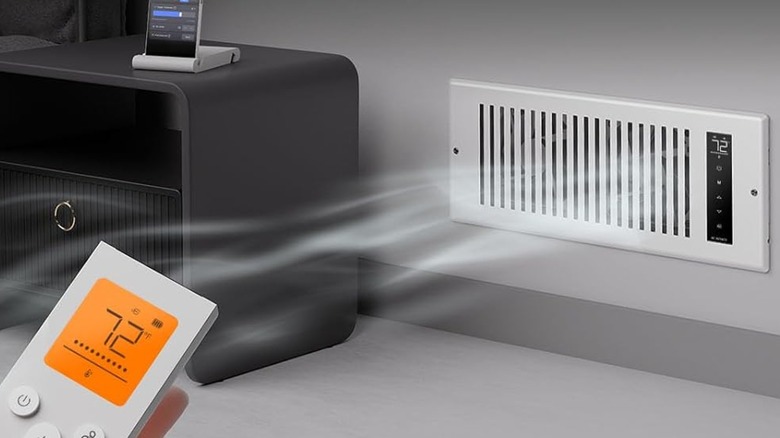 A person using the remote on the AC Infinity Airtap T4 Booster Fan.