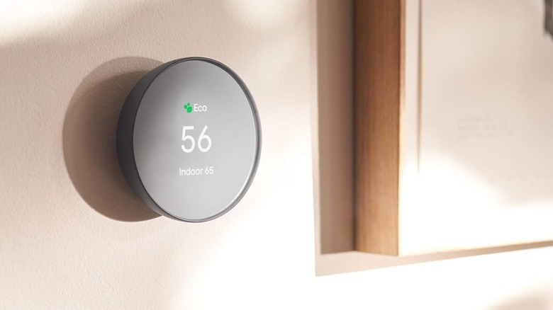 A Google Nest Thermostat on a wall.