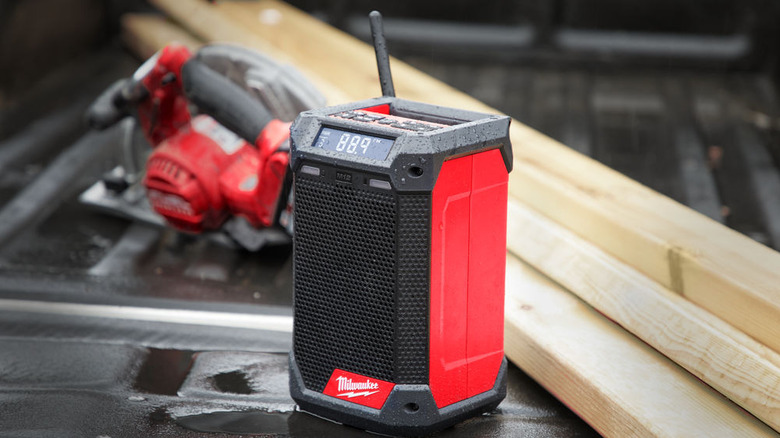 A black and red speaker with a screen displaying 88.9 on a job site