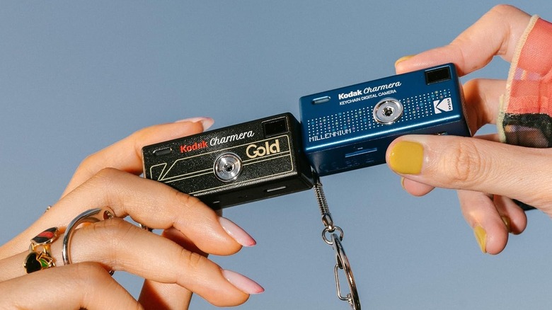 A women holding a couple of Kodak Charmera cameras