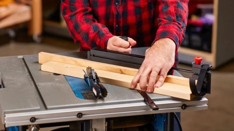 Person using Bauer 24-inch Fence and Miter Gauge to cut boards