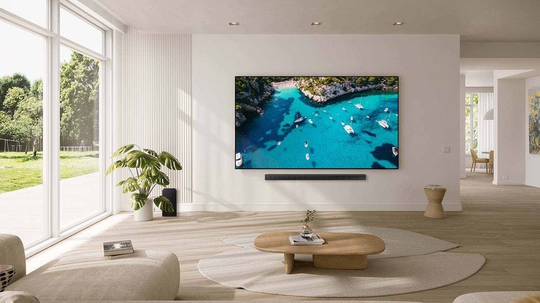 Samsung 98 inch Class Crystal UHD DU9000 displayed on wall in lounge area.