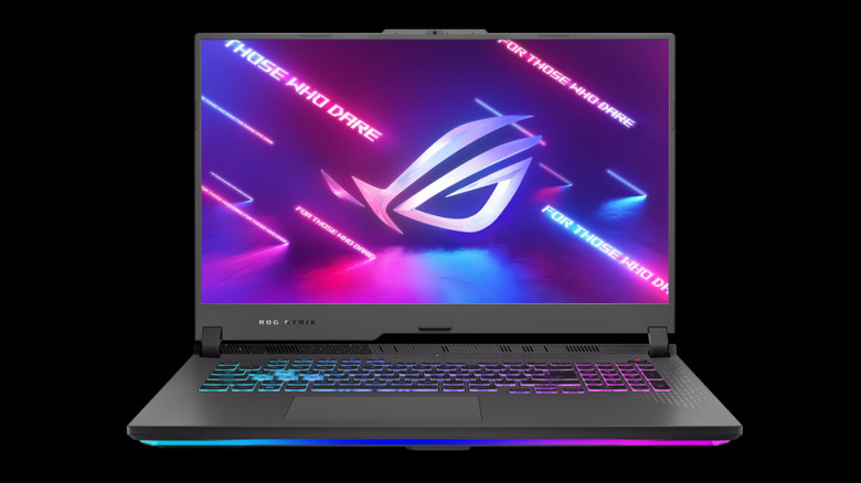 A 2023 version of the 17-inch gamign laptop, the Asus Rog Strix G17 against a black studio background with all lights on.