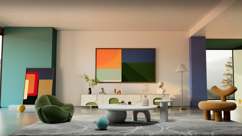 A HiSense Canvas TV in the 75 inch style mounted on the beige wall of a modern living room, displaying contemporary art.