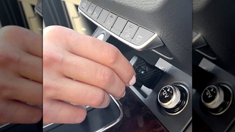 person plugging in car adapter