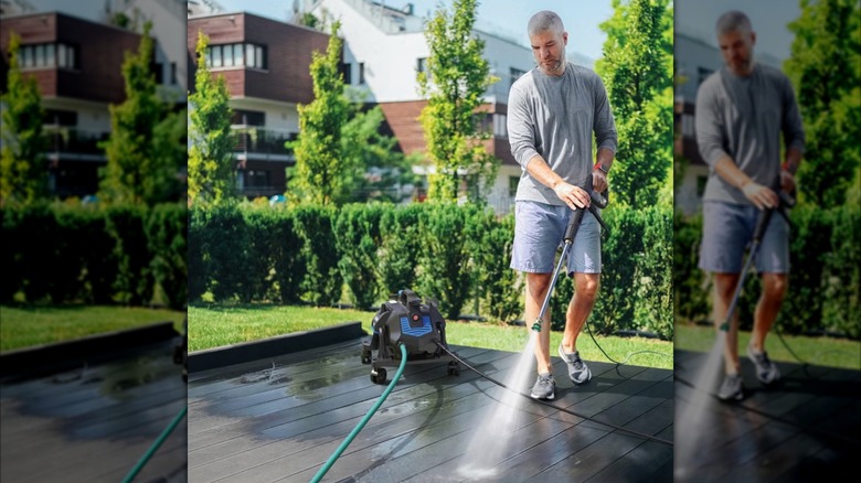 man cleaning patio with pressure washer
