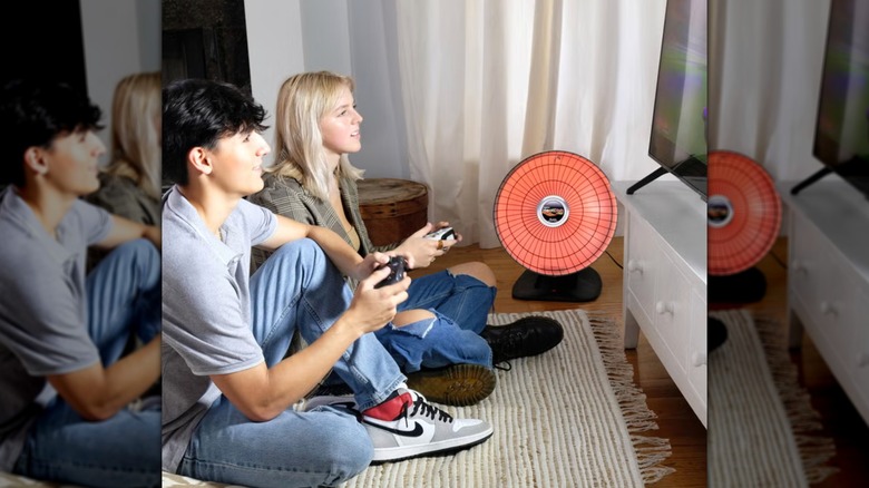 People playing games on TV with Presto heater beside them