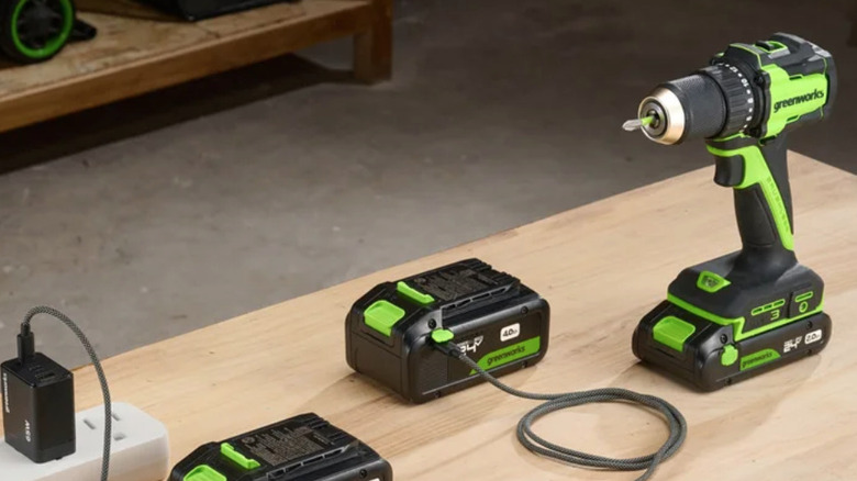 Greenworks power tools with batteries and charger on table