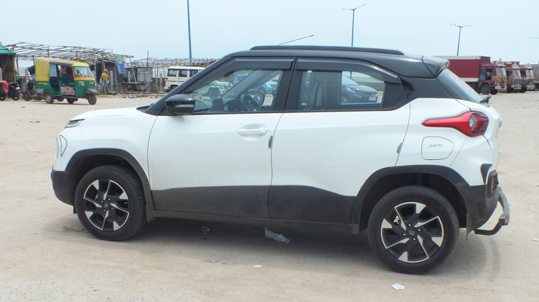 A white Tata Punch parked on a road in India.