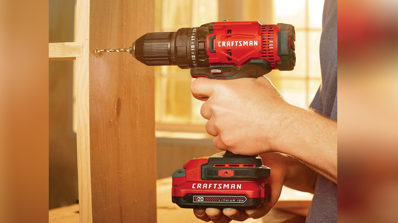 Craftsman V20 cordless drill/driver being used to drill a hole in timber.