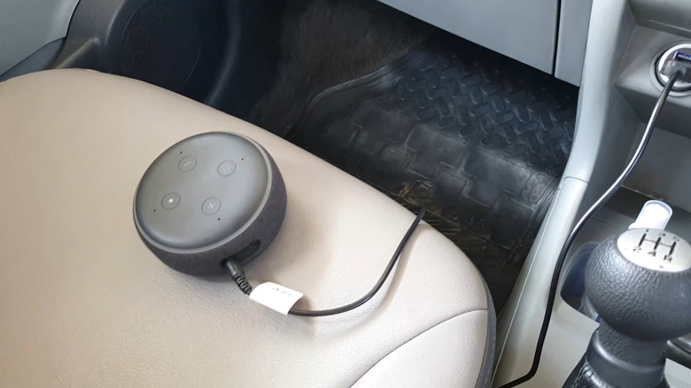 An Amazon Echo Dot connected to an old car via USB charger
