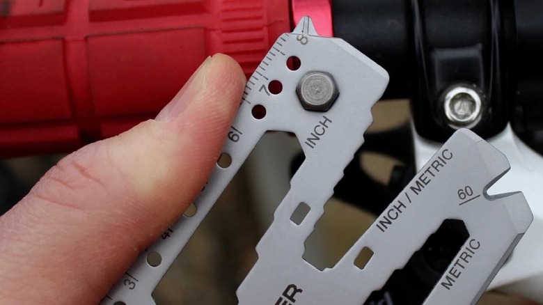 A person using a wrench on the Lever Gear Toolcard Pro.