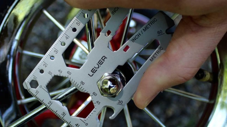 A person adjusting a fastener with the Lever Gear Toolcard Pro.