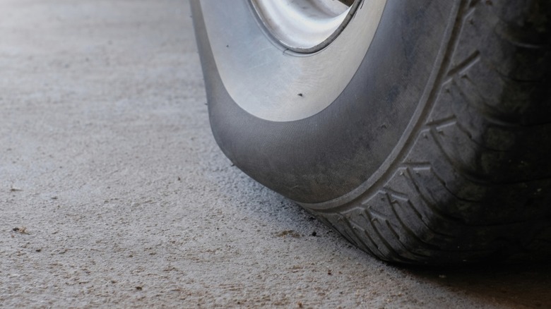 A closeup of bulging on a car tire.