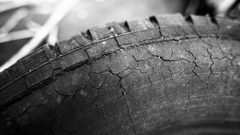 A closeup of cracks on a tire.