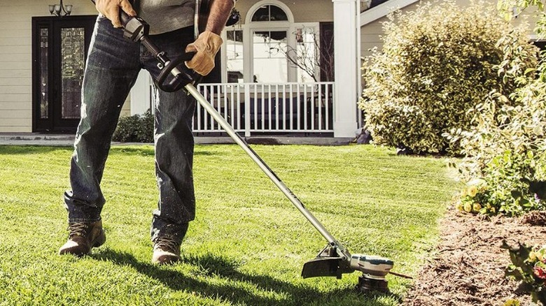 Person trimming lawn edge with 36V LXT Brushless String Trimmer