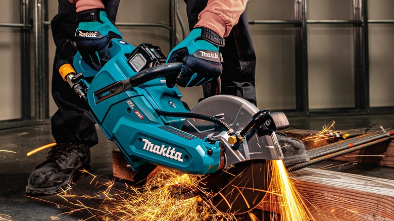 Person cutting steel with a Makita 40V Max XGT Brushless Cordless 9-inch Power Cutter