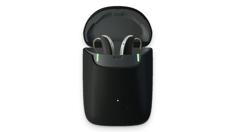 Rexton hearing aids in their open charging case over a white background