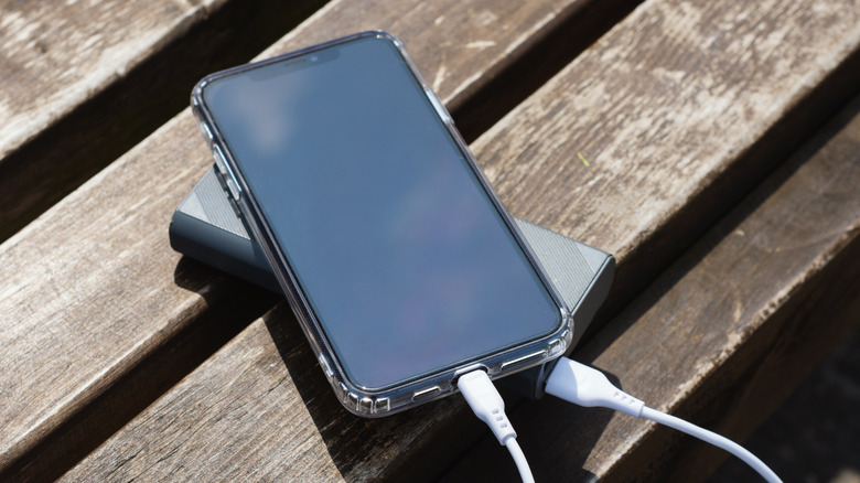An iPhone being charged via a power bank