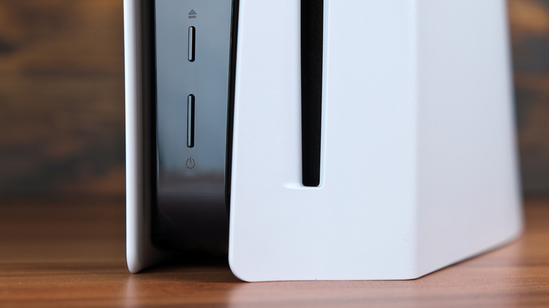 The bottom of a PS5 game console resting on a piece of furniture