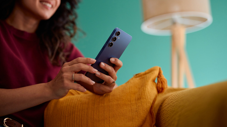 Girl using a smartphone in the living room