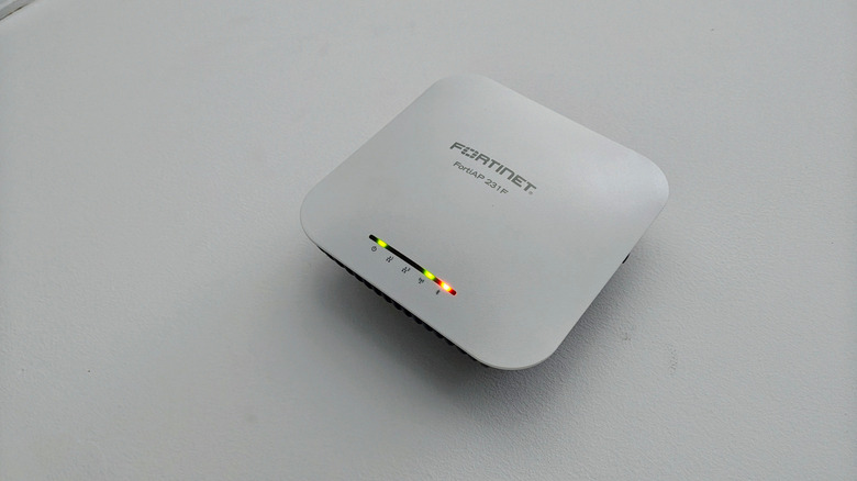 A Fortinet wireless access point on a grey surface