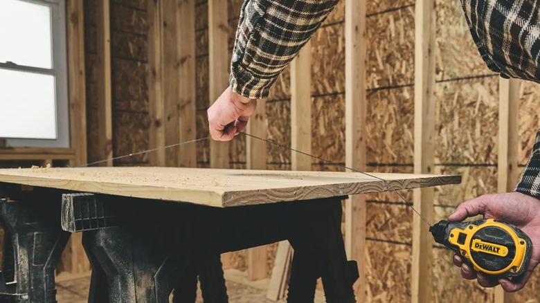snapping chalk line on a board