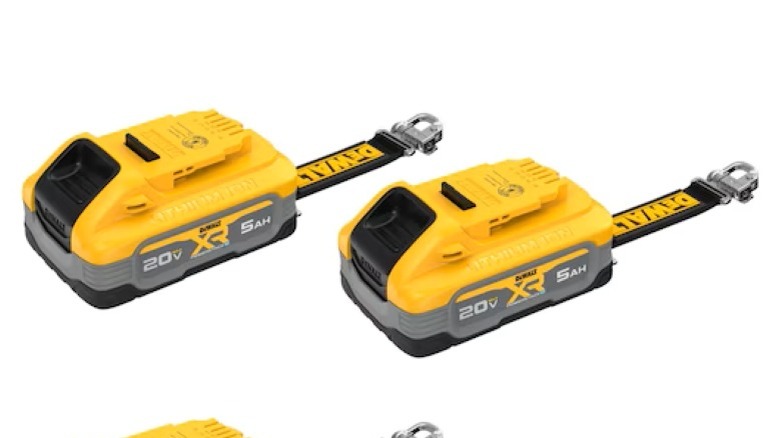 A pair of yellow and grey DeWalt power tool batteries on a white background