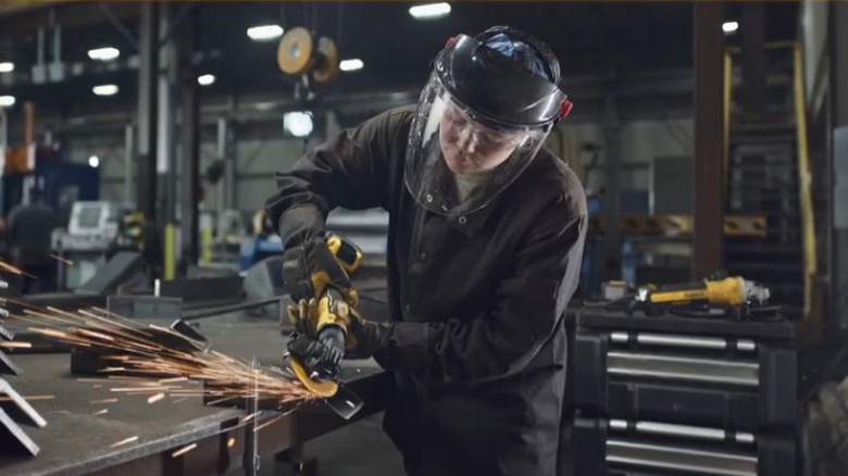 Person in a workshop using a grinder on metal