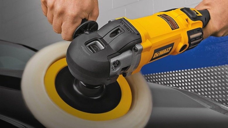 Person using DeWalt 12 amp 7-inch to 9-inch Soft Start Corded Car Buffer on car