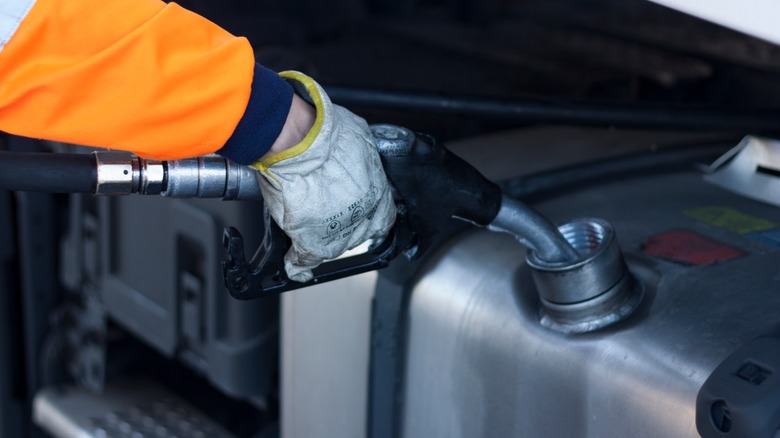 person fueling up car