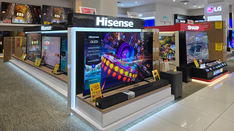 A Hisense QLED TV kept alongside other TVs in a store