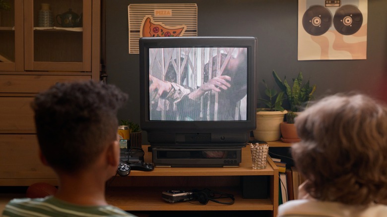 Two kids watching CRT TV