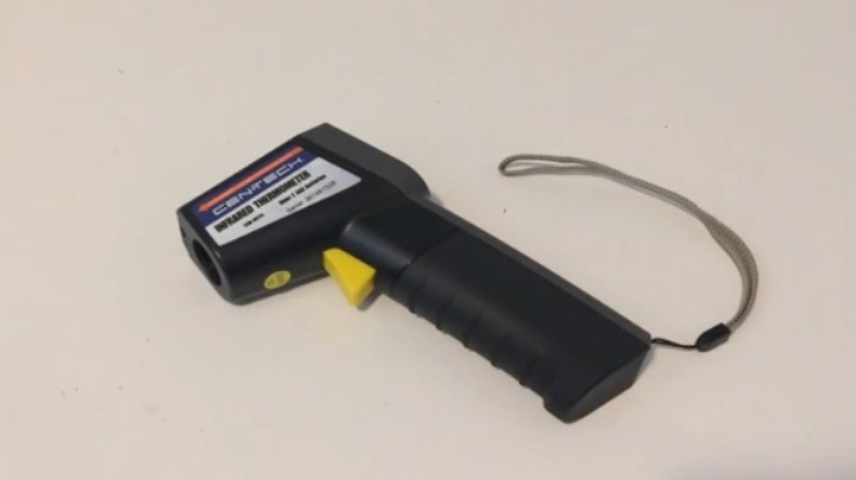 Cen-Tech Non-Contact Infrared Thermometer sitting on table