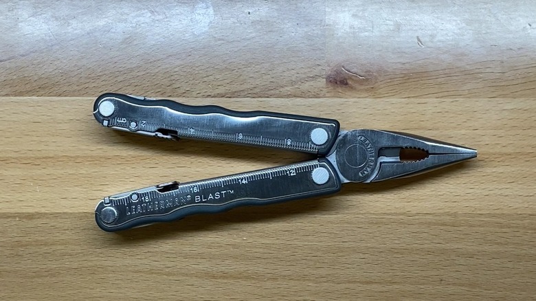 Leatherman Blast multi-tool on a wooden surface.