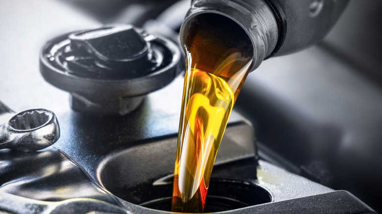 Close-up of oil poured into engine