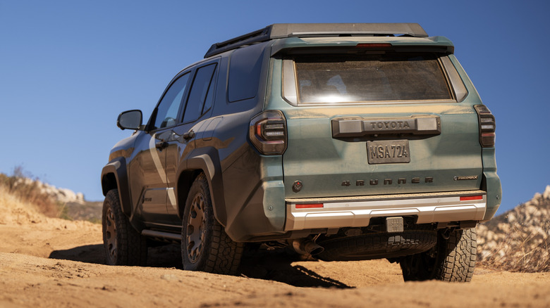 Rear view of green Toyota 4Runner on off-road trail.