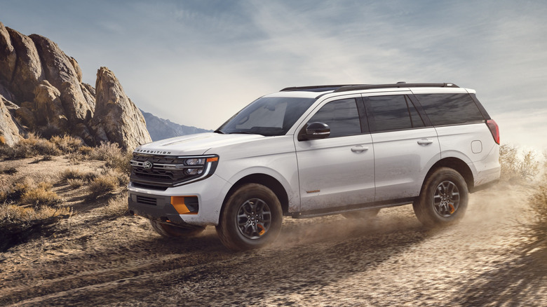 Side view of white Ford Expedition Tremor on desert trail.