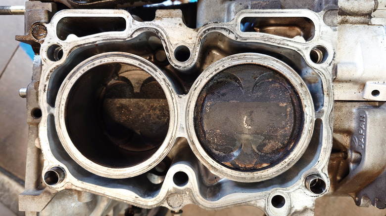 Boxer engine with head removed showing dirty piston heads
