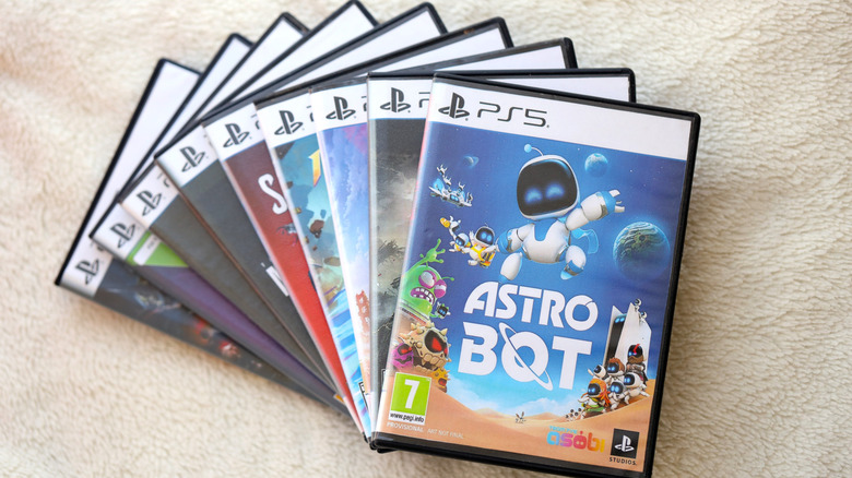 A large stack of PS5 game boxes.