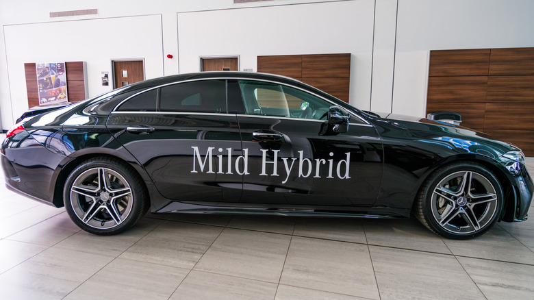 A side profile view of a Mercedes CLS in a showroom with 