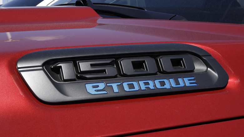 A close-up of a red RAM trucks eTorque hood emblem.